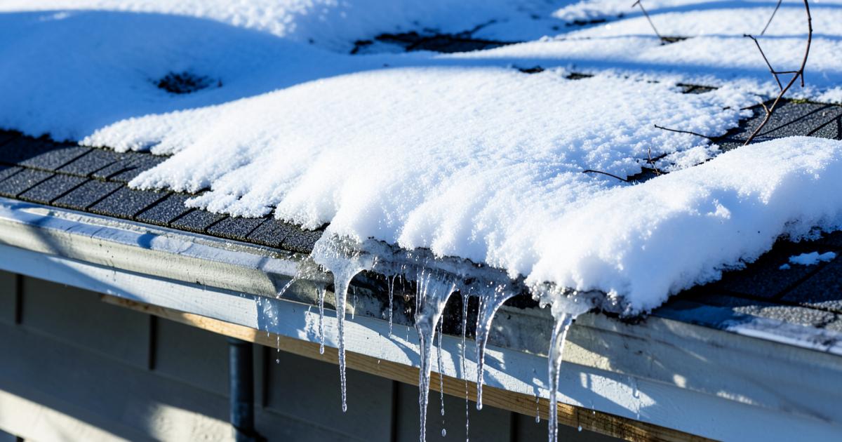 Snow-covered asphalt shingle roof in southern Maine during winter